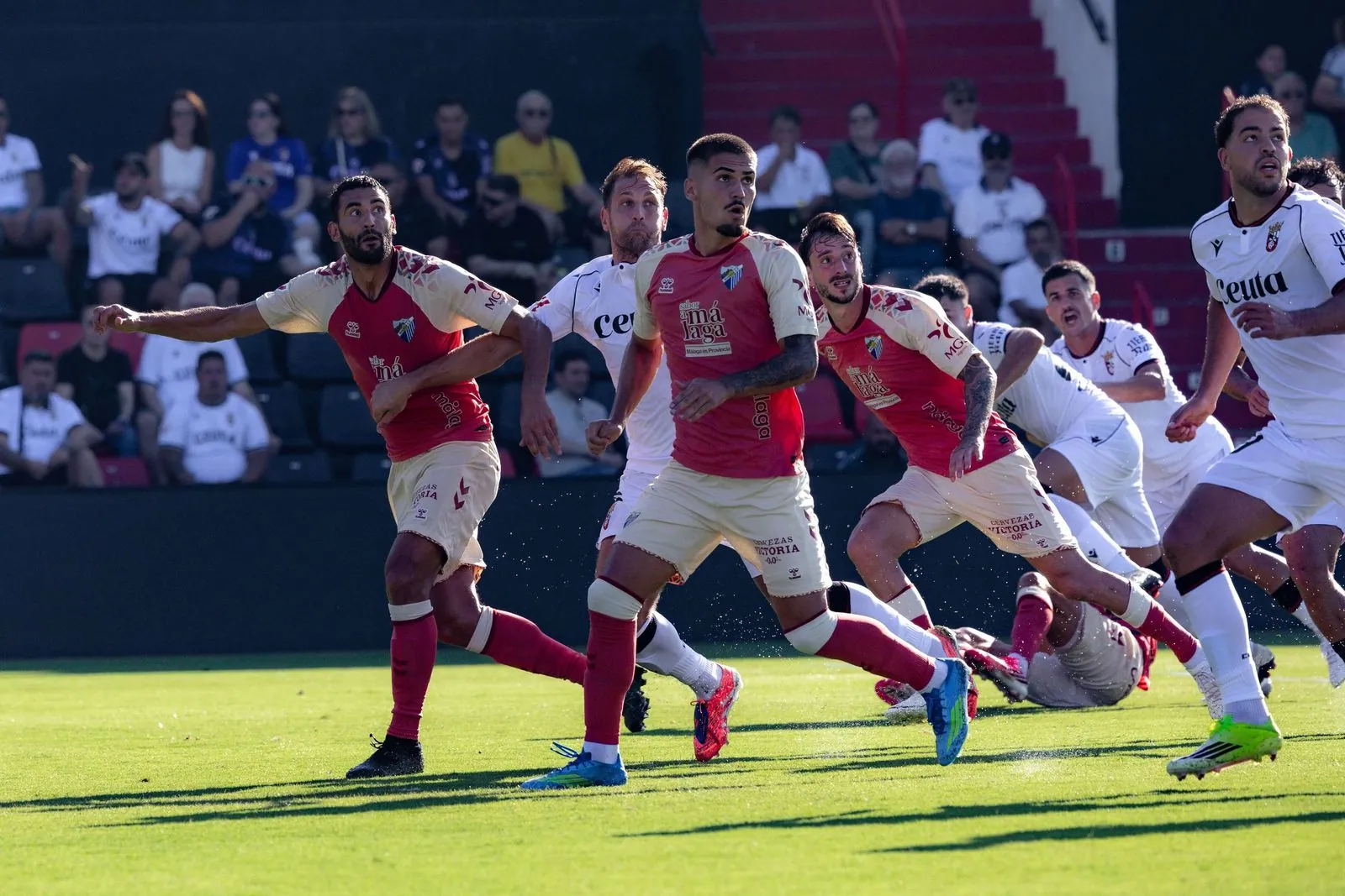 Futbolistas del Málaga CF en una acción defensiva en Ceuta.